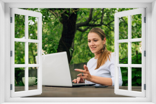 Happy beautiful young caucasian woman smiling and working at home