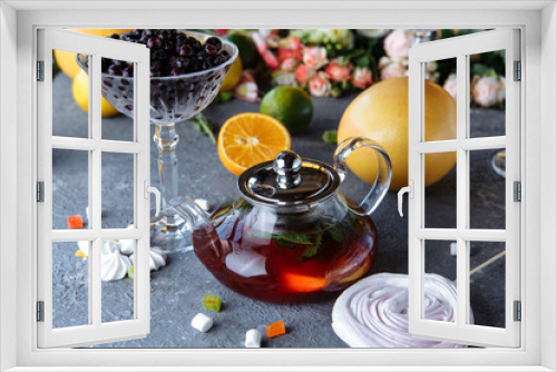 Fototapeta Naklejka Na Ścianę Okno 3D - Fruit tea with mint, oranges and cranberries on a decorative background. Hot winter drinks. A teapot of hot tea