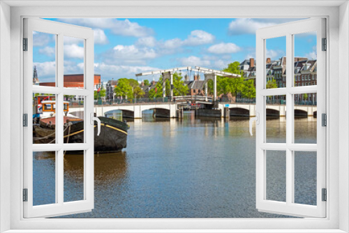 Fototapeta Naklejka Na Ścianę Okno 3D - City scenic from Amsterdam at the river Amstel in the Netherlands with the Tiny Bridge