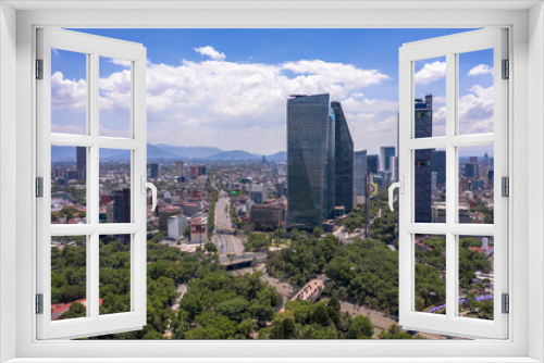 Aerial panoramic view of the tallest buildings in Mexico City with a blue sky as background.
