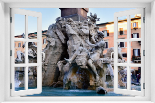 Fototapeta Naklejka Na Ścianę Okno 3D - Fountain of the Four Rivers on Piazza Navona. Ancient fountain, statues, obelisk design of Bernini. Famous landmark touristic location near Sant Agnese in Agone church in Rome, Italy