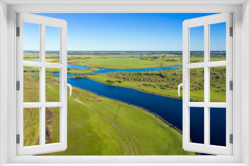 Fototapeta Naklejka Na Ścianę Okno 3D - Scenic aerial view of a river and green fields in a countryside
