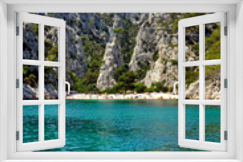 Fototapeta Naklejka Na Ścianę Okno 3D - People relaxing on a white beach and in the turquoise waters of a calanque near Marseille in the Mediterranean Sea.