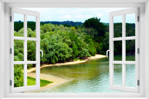 Fototapeta Naklejka Na Ścianę Okno 3D - beautiful green, blue and sand color river shore panorama. sandy beach and dense foliage. willow trees. various green colors. small bay and shallow water. outdoors and nature concept. beauty in nature