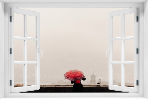 Fototapeta Naklejka Na Ścianę Okno 3D - Woman with a red umbrella watching the views