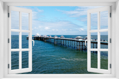 Fototapeta Naklejka Na Ścianę Okno 3D - Llandudno pier stretching out into the sea as seen from the Great Orme, in North Wales, United Kingdom.