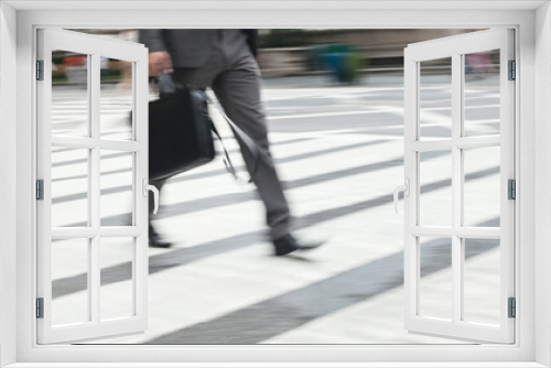 Businessman crossing city street