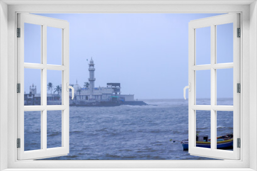 Fototapeta Naklejka Na Ścianę Okno 3D - A solo boat in a arabian sea at Mumbai with Haji Ali Dargah At background.