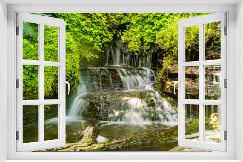 Fototapeta Naklejka Na Ścianę Okno 3D - Waterfalls with cascading water levels In the midst of nature With green trees looking fresh