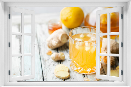 Fototapeta Naklejka Na Ścianę Okno 3D - Yellow drink with ginger, lemon and ice in a glass, refreshing homemade ginger lemonade or ale on white background