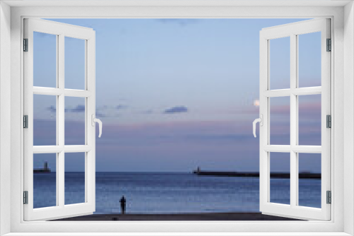 Fototapeta Naklejka Na Ścianę Okno 3D - Woman looking out to sea in the evening at South Shields