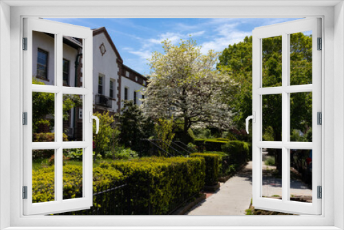 Fototapeta Naklejka Na Ścianę Okno 3D - Beautiful Spring Sidewalk Scene with Old Homes and Green Gardens in Astoria Queens New York