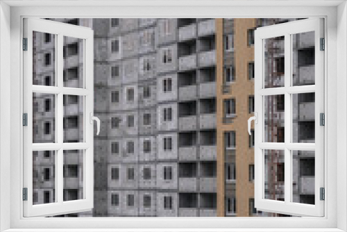Fototapeta Naklejka Na Ścianę Okno 3D - Large construction site on a background of blue sky. Brick, panel apartment building. Industrial theme for design