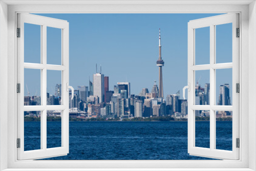Fototapeta Naklejka Na Ścianę Okno 3D - A panoramic view of Toronto, Ontario, Canada, and Lake Ontario, on a summer day with blue and clear sky
