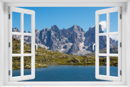 Fototapeta Naklejka Na Ścianę Okno 3D - lake and pala group mountain summits pale di san Martino in blue sky