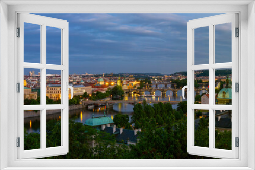 Fototapeta Naklejka Na Ścianę Okno 3D -  Panoramic view of the  illuminated cityscape and bridges of Prague,  including the famous Charles Bridge and old town. Summer evening , just after sunset time. Czech Republic.