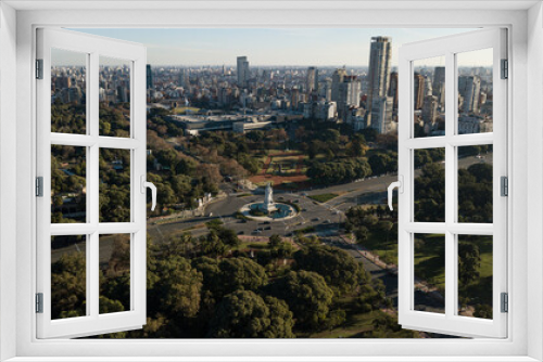 Aerial view on the empty big avenue and roundabout in between of the public parks and gardens, during the sunset and quarantine due to coronavirus, Buenos Aires, Argentina