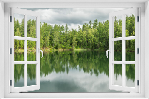 Fototapeta Naklejka Na Ścianę Okno 3D - Wild forest lake. Gloomy sky, beautiful reflection. Travel and summer vacation.