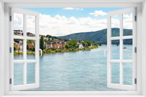 Fototapeta Naklejka Na Ścianę Okno 3D - An old, historic city on the banks of the River Rhine in western Germany, visible city buildings, bridge and barge on the water.