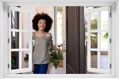 Mixed race woman holding a door handle