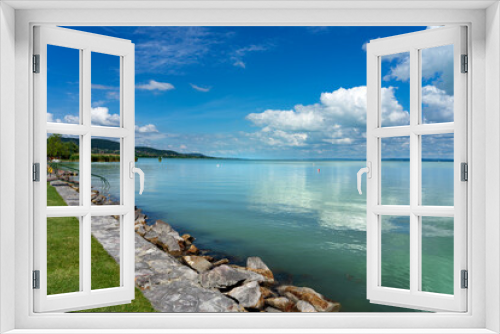 Fototapeta Naklejka Na Ścianę Okno 3D - simple picture about Lake Balaton in Hungary from Badacsony beach with blue sky and cloud refletion and stairs into the water
