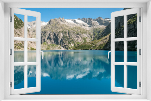 Fototapeta Naklejka Na Ścianę Okno 3D - Reflections in the turquoise water of lake Gelmer.