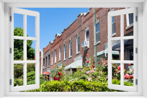 Fototapeta Naklejka Na Ścianę Okno 3D - Row of Old Brick Homes with Beautiful Gardens with Flowers during Spring in Sunnyside Queens New York