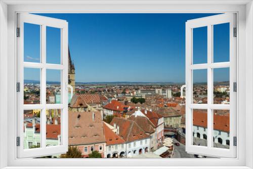 SIBIU, ROMANIA - Circa 2020: High view of old medieval town with cloudy blue sky. Beautiful tourist spot in eastern central Europe. Aerial view of famous Evangelic Church in Sibiu Romania