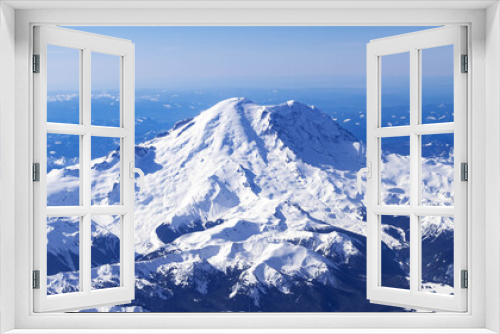 Fototapeta Naklejka Na Ścianę Okno 3D - Aerial View of Idaho mountains from the sky while inside an airplane. View of brown mountains and trees covered with snow