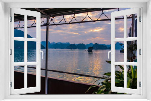 Fototapeta Naklejka Na Ścianę Okno 3D - view from a tourist boat deck of the evening skies on Halong Bay among the limestone karsts
