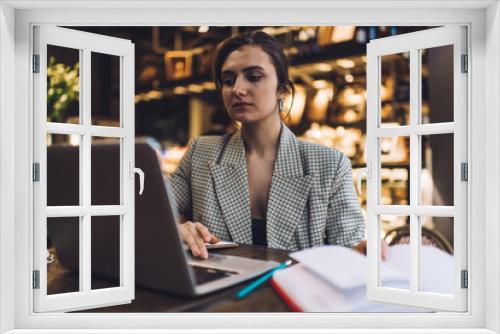 Tired woman using laptop in cafe