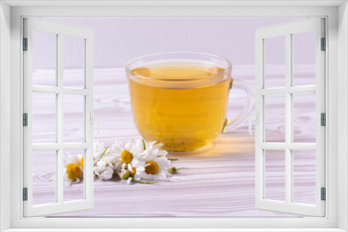 Fototapeta Naklejka Na Ścianę Okno 3D - herbal fresh hot tea in a glass cup and camomile flowers