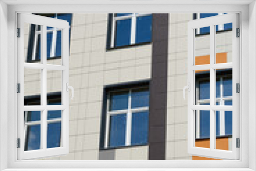 Fototapeta Naklejka Na Ścianę Okno 3D - facade of a modern building on a bright Sunny day, siding and Windows, beautiful exterior of the new building