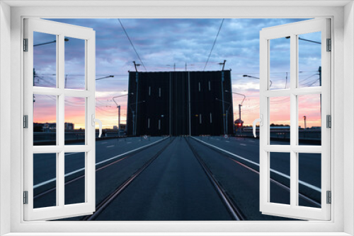 Fototapeta Naklejka Na Ścianę Okno 3D - empty road with rails at a posh dawn against the backdrop of a drawbridge
