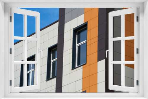 Fototapeta Naklejka Na Ścianę Okno 3D - facade of a modern building on a bright Sunny day, siding and Windows, beautiful exterior of the new building