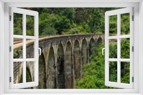 Fototapeta Naklejka Na Ścianę Okno 3D - Nine arches Bridge in highlands near Ella, Sri Lanka. Jungle and tea plantation all around. Portrait format