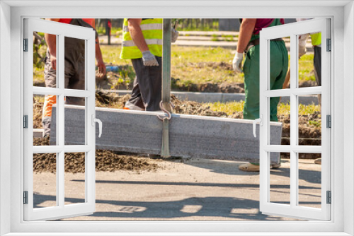 Fototapeta Naklejka Na Ścianę Okno 3D - unloading concrete curbs. the installation of new curbs
