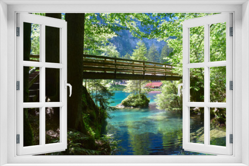 Fototapeta Naklejka Na Ścianę Okno 3D - A bridge over a magnificent crystal-clear blue lake in the mountains. Swiss Alps. Summer mountain landscape. Blue water, forest.