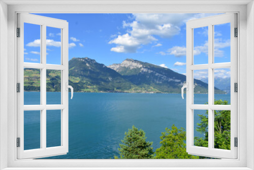 Fototapeta Naklejka Na Ścianę Okno 3D - Magnificent view of lake Thun and the Alps, Switzerland. Blue sky, blue water, boats, green trees. Sunny summer weather.