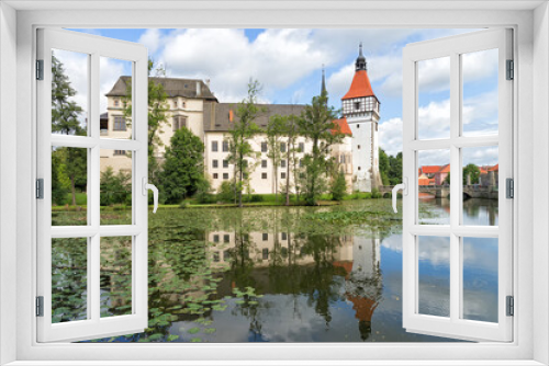 Fototapeta Naklejka Na Ścianę Okno 3D - View of the Blatna Castle in the Czech Republic with reflection in the water.