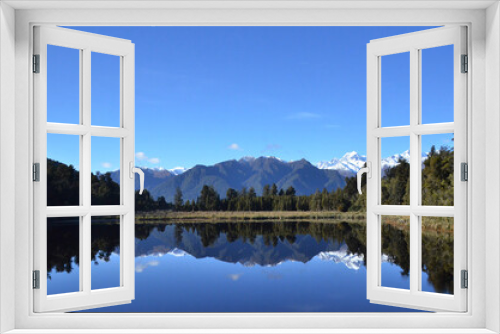Fototapeta Naklejka Na Ścianę Okno 3D - Lake Matheson, near the Fox Glacier in South Westland, New Zealand, is famous for its reflected views of Aoraki/Mount Cook and Mount Tasman.