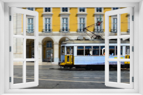 Fototapeta Naklejka Na Ścianę Okno 3D - Vintage yellow tramway at the Commerce Square, in Lisbon, Portugal. Photography made using the panning technique.