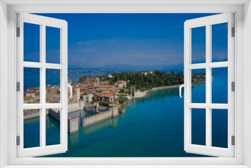 Fototapeta Naklejka Na Ścianę Okno 3D - The famous Sirmione Castle, good weather. Aerial view of the castle. Castle reflections in the water Sirmione, Lake Garda, Italy.