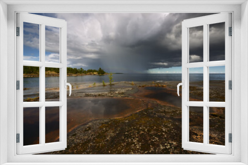 Fototapeta Naklejka Na Ścianę Okno 3D - Storm cloud over a rocky island, Ladoga lake