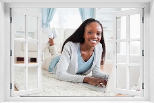 Woman lying on the floor with her laptop