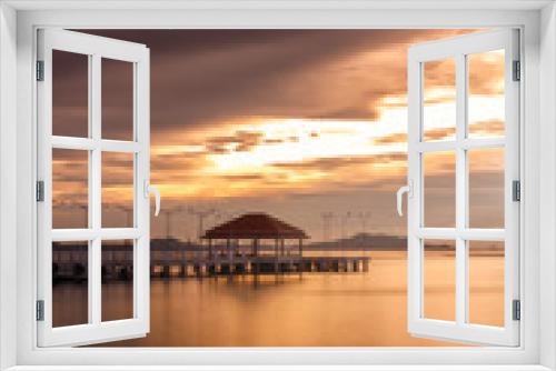 Fototapeta Naklejka Na Ścianę Okno 3D - Sunset seascape with bridge and dramatic sky.