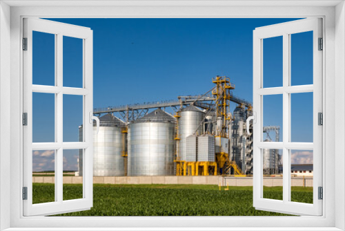 Fototapeta Naklejka Na Ścianę Okno 3D - silver silos on agro-processing and manufacturing plant for processing drying cleaning and storage of agricultural products, flour, cereals and grain. Granary elevator.