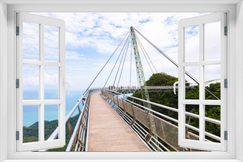 Fototapeta Naklejka Na Ścianę Okno 3D - The sky bridge in the north of Langkawi, Malaysia. The landmark of the small Malaysian Island. One pillar and 12 cable holding the bridge over the valley. A  breathtaking view over the Andaman Sea 
