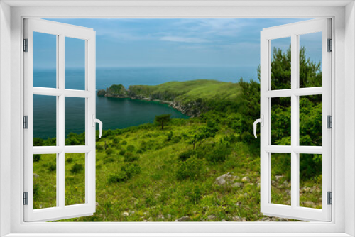 Fototapeta Naklejka Na Ścianę Okno 3D - Ocean and green hills view