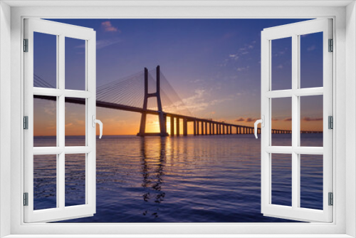 Fototapeta Naklejka Na Ścianę Okno 3D - Sunrise at Vasco da Gama Bridge, the longest bridge in Europe, who spans the Tagus River, in Lisbon, Portugal.